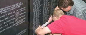 James Dean, left, assisted Ricky Brown in etching his uncle’s name from the Tennessee Vietnam Veterans Memorial Wall displayed in Cleveland, TN. PHOTO BY Joyanna Love, The Cleveland Daily Banner