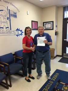 Ray Pawlicki presented a check to Julie Marks,    Principal,    Chester W. Taylor Elementary School